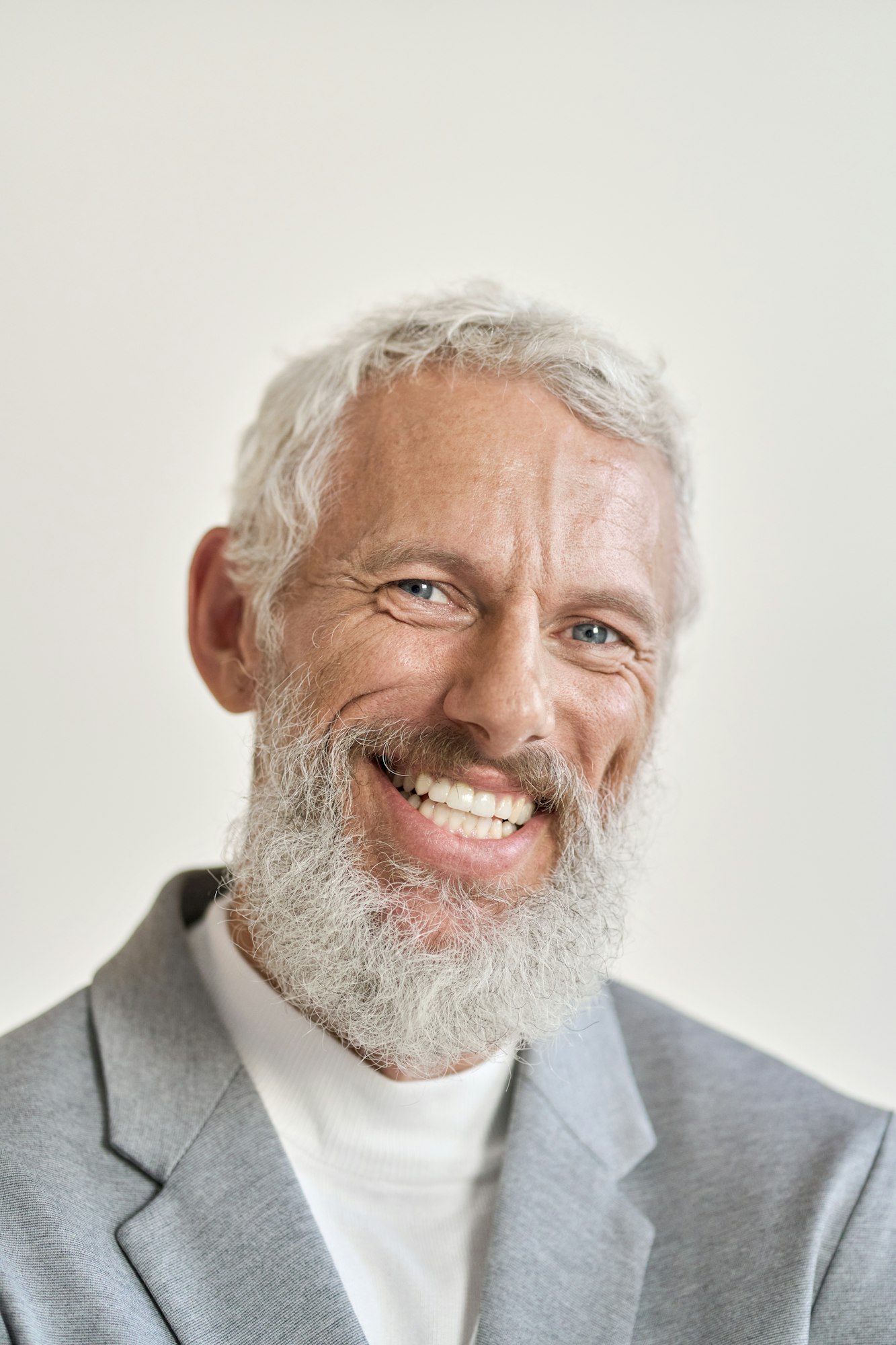 Happy old business man isolated on white, vertical headshot portrait.